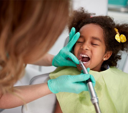 Child receives dental cleaning