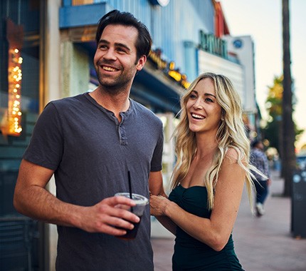 Couple on a date smiling outside