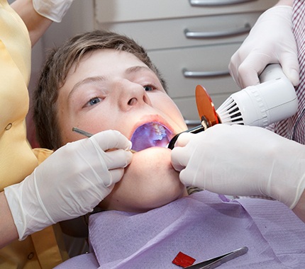 Teen receiving a dental sealant
